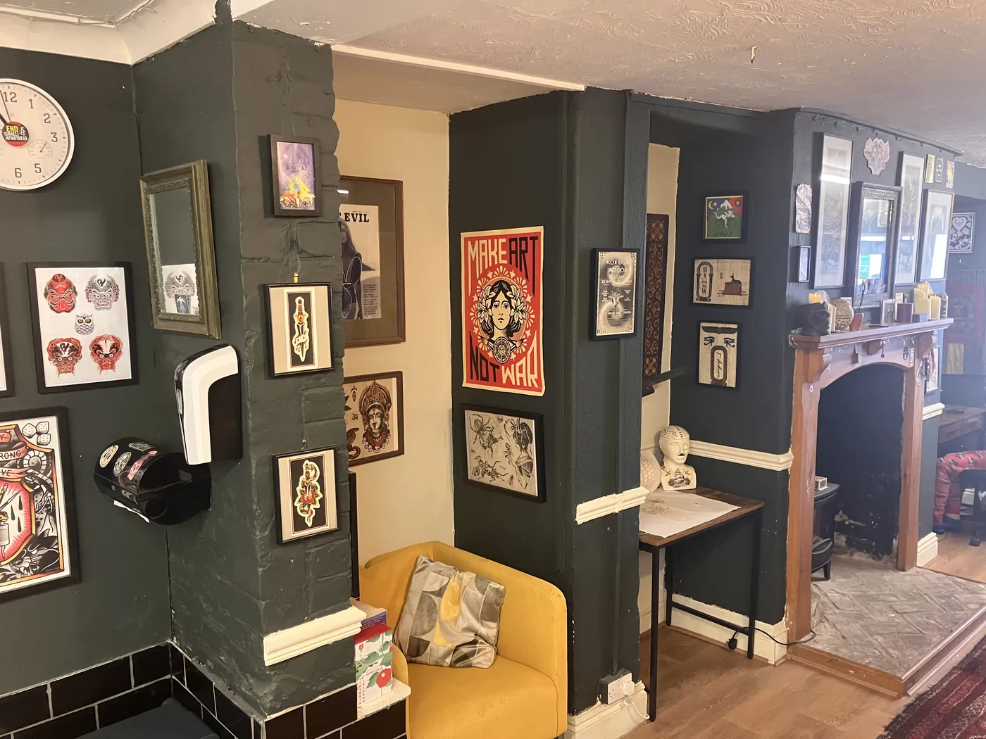 The waiting area: a comfy sofa by the fireplace, surrounded by artwork.
